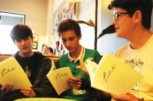 Photo by ERIN FLAHERTY From left, Haas Hall Bentonville scholars, junior Shiloh Beeler, freshman Matthew Mitchell and junior Tyler Kowalski, wait to read their pieces.