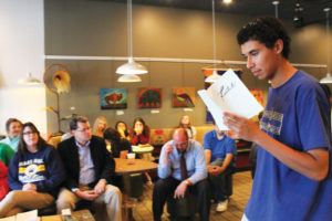 Photo by ALLISON THOMEY Junior Javian Walter reads junior Owen Young’s “The Ballad of Will Blister” at the release party for the second volume of “Footnotes,” Haas Hall’s literary arts magazine, at Red Kite Coffee Co. in Fayetteville on Aug. 26.